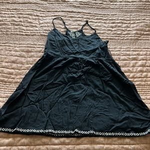 An embroidered mini racer back black dress
